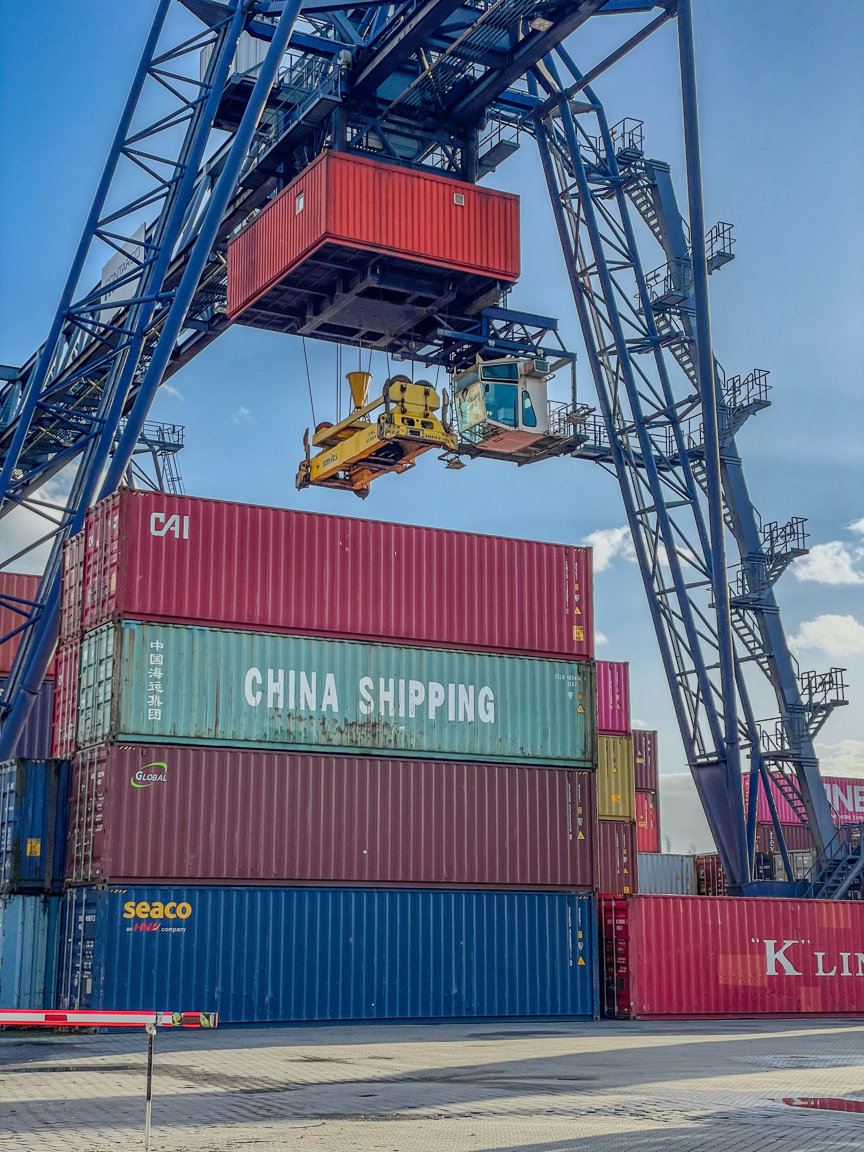 Container ship being handled at a busy port terminal